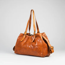 Load image into Gallery viewer, Avalon tan Italian leather shoulder tote, angled view with antique brass buckles and crossbody strap