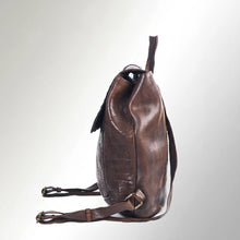 Load image into Gallery viewer, Side view of the Sawyer brown leather backpack showing the slim profile, top handle, and adjustable strap buckles