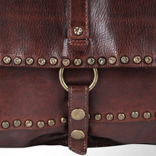 Load image into Gallery viewer, Close-up of star-stamped antique brass studs and brass ring on dark brown leather