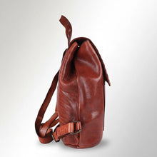 Load image into Gallery viewer, Side view of the Sawyer cognac leather backpack showing pebbled leather, top handle, and strap buckle