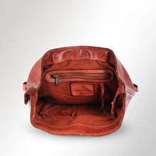 Load image into Gallery viewer, Inside the Sawyer cognac leather backpack showing the lined main compartment, interior zip pocket, and slip pockets