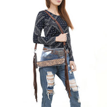 Load image into Gallery viewer, Woman wearing the Two Step clear crossbody purse with hand tooled floral panel and long brown leather fringe