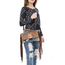 Load image into Gallery viewer, Woman wearing the Palomino clear fringe crossbody purse with hand tooled horse and sunflower flap