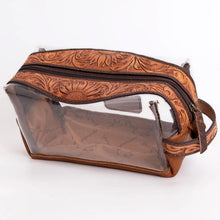 Load image into Gallery viewer, Prairie Bloom hand tooled leather clear toiletry bag with antique brass zipper, angled view