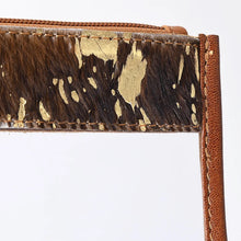 Load image into Gallery viewer, Close-up of the metallic gold finish on the hair-on cowhide band of the Gold Dust wristlet