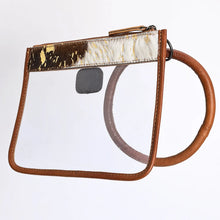 Load image into Gallery viewer, Gold Dust cowhide leather clear wristlet clutch with rolled leather bangle loop, angled view