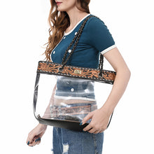 Load image into Gallery viewer, Woman carrying the Midnight Bloom clear tote on her shoulder by its chain-and-leather handles