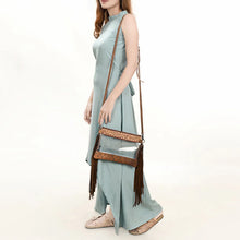 Load image into Gallery viewer, Woman in a sage dress wearing the Brass Tacks clear fringe crossbody purse in Tan