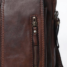 Load image into Gallery viewer, Close-up of the vertical zip pocket on dark brown hand-rubbed Italian leather