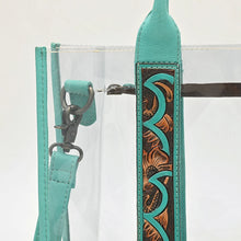 Load image into Gallery viewer, Close-up of the hand tooled floral strap accent with turquoise-painted scallops and antique swivel clip on the Turquoise Trail tote