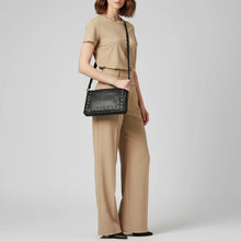 Load image into Gallery viewer, Woman wearing the black Margo studded Italian leather organizer crossbody
