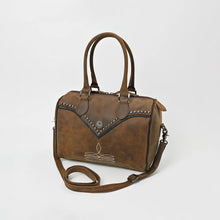 Load image into Gallery viewer, Bowie western satchel in distressed brown leather, angled view showing the barrel shape, black edge piping, studded V-yoke, and adjustable removable strap