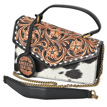 Load image into Gallery viewer, Domino hand-tooled cowhide messenger crossbody, three-quarter view with chain and leather shoulder pad