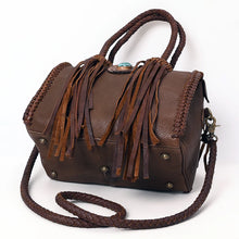 Load image into Gallery viewer, Reata leather barrel satchel in Chocolate, angled view of the base with antique brass feet and fringe