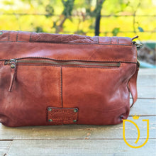 Load image into Gallery viewer, Close-up of the Venezia cognac Italian leather back zip pocket and hand-dyed leather finish