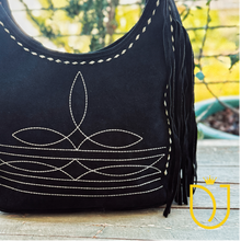 Load image into Gallery viewer, Close-up of cream boot-stitch embroidery and buck-stitch lacing on the Onyx black suede hobo bag