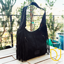 Load image into Gallery viewer, Onyx suede hobo bag back, angled view with diamond-stitched shoulder strap, zip pockets and fringe