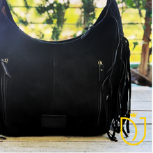 Load image into Gallery viewer, Close-up of the Onyx hobo bag back with two zip pockets, antique brass-finish pulls and suede fringe