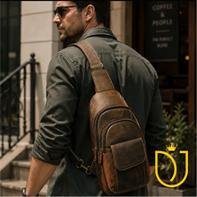 Load image into Gallery viewer, Drifter distressed brown leather sling bag worn across the back, showing the front flap pocket, two zip compartments, and brass swivel-clip strap