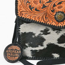 Load image into Gallery viewer, Close-up of Magpie hand-carved sunflower tooling, two-tone floral concho and hair-on cowhide