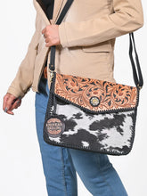 Load image into Gallery viewer, Magpie hand tooled cowhide crossbody worn over a camel blazer and jeans, close view