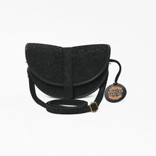 Load image into Gallery viewer, Front view of the Nightshade half moon saddle crossbody in black floral embossed suede