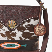 Load image into Gallery viewer, Close-up of Ocotillo's hand-tooled scrollwork, whipstitch trim, cactus-and-sunrise concho and hand-painted southwest arrow