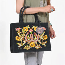 Load image into Gallery viewer, Lady Luck embroidered black suede tote carried on the arm, close view