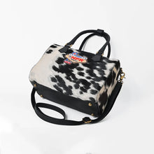 Load image into Gallery viewer, Tuff black and white hair-on cowhide speedy bag with PRCA patch and NFR charm