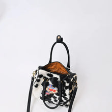 Load image into Gallery viewer, Tuff black and white hair-on cowhide speedy bag with PRCA patch and NFR charm