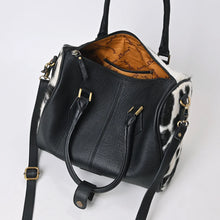 Load image into Gallery viewer, Tuff black and white hair-on cowhide speedy bag with PRCA patch and NFR charm