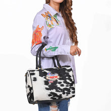 Load image into Gallery viewer, Tuff black and white hair-on cowhide speedy bag with PRCA patch and NFR charm