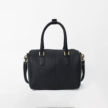 Load image into Gallery viewer, A black pebbled leather handbag with double top handles and a detachable shoulder strap, featuring gold-tone hardware, photographed against a plain white background.