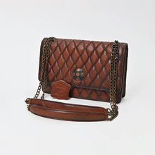 Load image into Gallery viewer, Sorrel quilted cognac leather flap bag with copper-and-black concho and antique bronze chain strap, three-quarter view