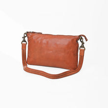 Load image into Gallery viewer, Angled view of the Tawny cognac slim leather crossbody with zip top and detachable stitched leather strap