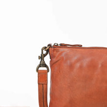 Load image into Gallery viewer, Close-up of the antique brass swivel clip, zip pull, and stitched strap on the Tawny cognac leather crossbody