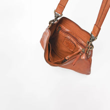 Load image into Gallery viewer, Inside the Tawny cognac leather crossbody showing the lined main compartment, interior zip pocket, and key clip