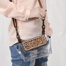 Load image into Gallery viewer, Black-Eyed Susan clear crossbody purse worn at the hip, tooled leather flap and black swivel clips
