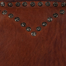 Load image into Gallery viewer, Close-up of the Emmylou cognac tote showing antique brass studs set in a V-shaped western yoke along the topline
