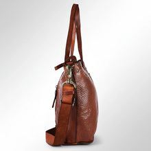 Load image into Gallery viewer, Side view of the Emmylou cognac leather tote showing its depth, shoulder handles, front zip pocket and brass swivel strap clip
