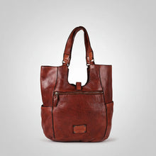 Load image into Gallery viewer, Back of the Sedona cognac-red leather tote with zip pocket, side pockets and embossed brand plate
