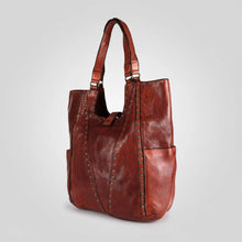 Load image into Gallery viewer, Sedona Italian leather studded slouch tote, angled view showing rivet trim and side pocket
