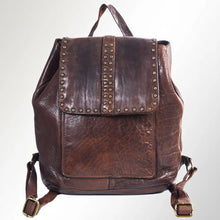 Load image into Gallery viewer, Front view of the Sawyer brown Italian leather backpack with star-studded flap, studded center stripe, top handle, and antique brass strap buckles
