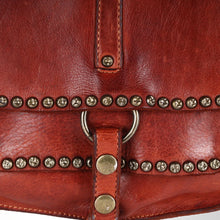 Load image into Gallery viewer, Close-up of star-stamped antique brass studs, brass ring, and snap strap on cognac leather
