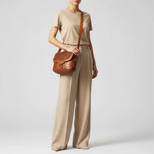 Load image into Gallery viewer, Woman wearing the Lucca cognac woven Italian leather messenger bag crossbody
