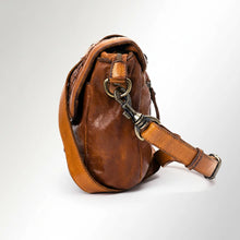 Load image into Gallery viewer, Lucca woven Italian leather messenger crossbody in cognac, side view showing antique brass swivel clip and adjustable strap buckle
