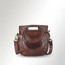 Load image into Gallery viewer, Front view of the Selene brown leather handbag with layered crescent panels, studded cut-out clutch handle, and detachable shoulder strap
