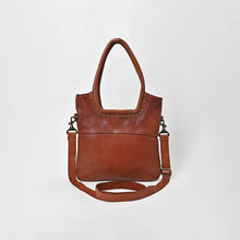 Load image into Gallery viewer, Sienna studded leather crossbody tote in cognac, front view with brass studs around the handle opening and adjustable leather strap
