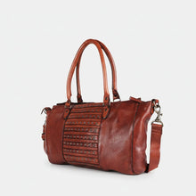 Load image into Gallery viewer, Rowan studded leather satchel in cognac, angled view showing the studded center panel, pebbled leather and strap clip
