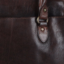 Load image into Gallery viewer, Close-up of Marlowe dark brown Italian leather grain with antique brass handle ring and rivets
